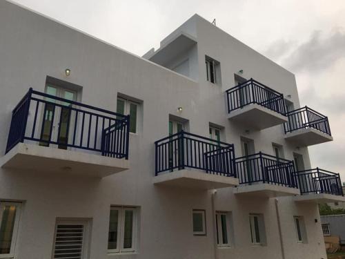 a white building with blue balconies on it at Blue House in Jincheng