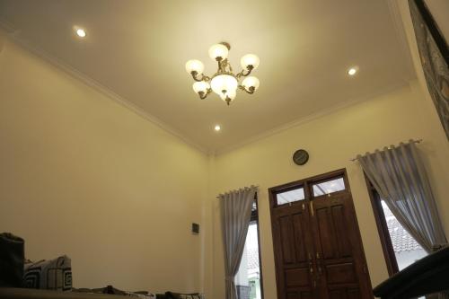 a chandelier hanging from a ceiling in a room at Sayana Homestay in Sleman