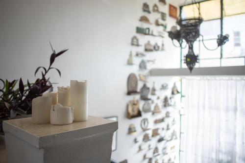 a room with a bunch of candles on a wall at Tzefania Hotel in Jerusalem