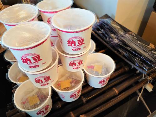 a group of cups sitting on top of a grill at Green Rich Hotel Kyoto Station South (Artificial hot spring Futamata Yunohana) in Kyoto