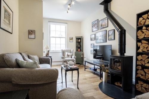 a living room with a couch and a fireplace at 107 Nunnery Lane - a House of York holiday home in York