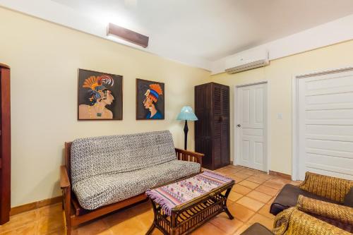 a living room with a couch and a table at Beachside Villas Gold Standard Certified in Placencia Village