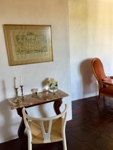 a table with two candles and a chair in a room at El Molino Estepona in Estepona