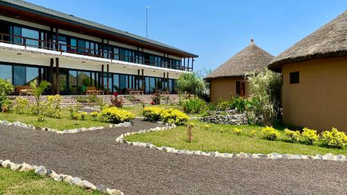 a building with a garden in front of a building at Lemon Beach Resort in Elmina