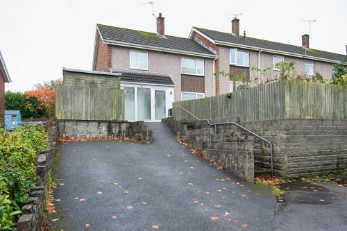 a house with a fence and a driveway at Private Parking, Garden, Close to Beach! in Swansea