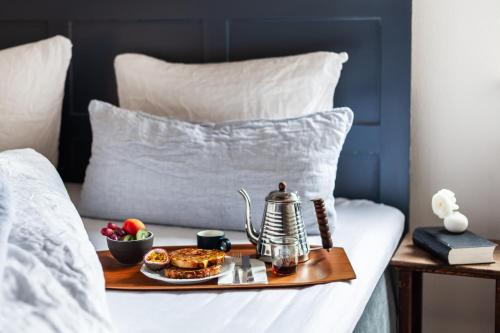 a tray of breakfast food on a bed at Hotel Die Reederin in Lübeck