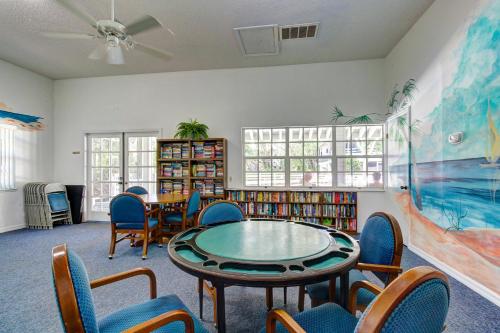 a library with a table and chairs in a room at Buddy's Place at the Beach in New Smyrna Beach