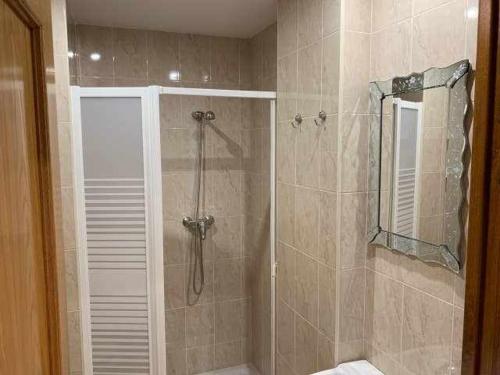 a bathroom with a shower with a glass door at Cumbres De Los Picos Apartamento "Rebecos" in Poo de Cabrales