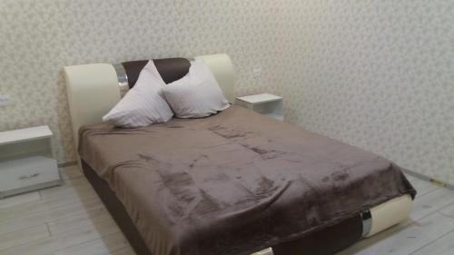 a bedroom with a bed with two pillows on it at Будинок для гостей по вул. Шевченка in Berehove