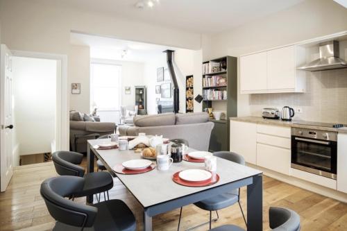 a kitchen and living room with a table and chairs at 107 Nunnery Lane - a House of York holiday home in York