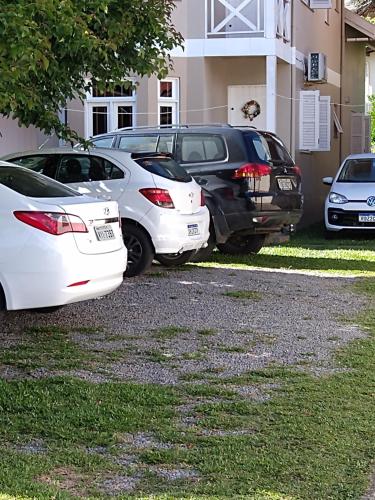 a group of cars parked in front of a house at Pousada Genial in Gramado