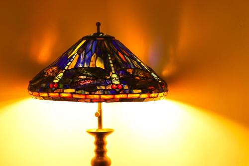 a stained glass lamp sitting on top of a table at Tzefania Hotel in Jerusalem