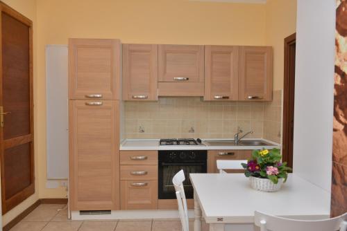 a kitchen with wooden cabinets and a white counter top at RietINN 1 in Rieti