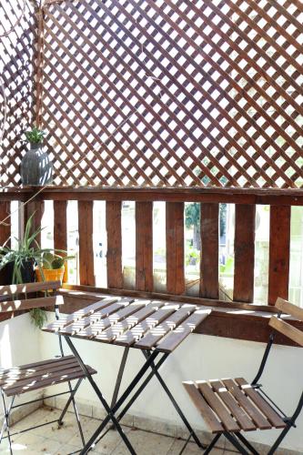 a pair of chairs and a table on a porch at Tzefania Hotel in Jerusalem