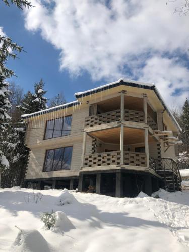 a building with snow in front of it at RIVIERA in Lekechi