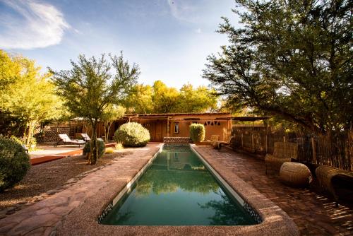 a swimming pool in the yard of a house at Naturalis Hotel in San Pedro de Atacama