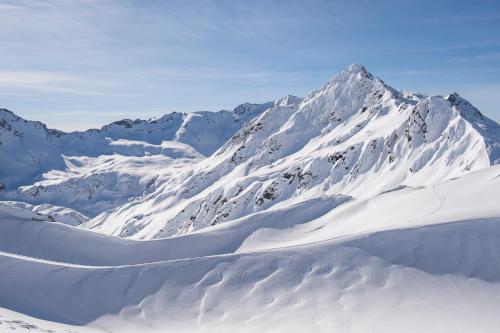 a mountain covered in snow with a mountain at House Hannes Schneider Stuben in Stuben am Arlberg