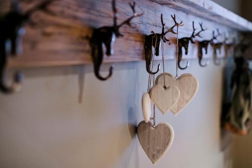 a bunch of hearts hanging on a wall at House Hannes Schneider Stuben in Stuben am Arlberg