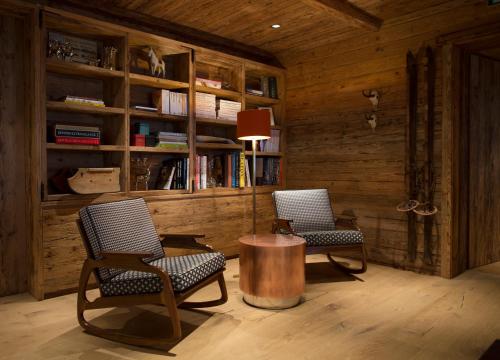 two chairs and a table with a lamp in a room at House Hannes Schneider Stuben in Stuben am Arlberg
