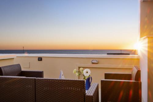 a balcony with chairs and a view of the ocean at Living Room in Leuca in Leuca