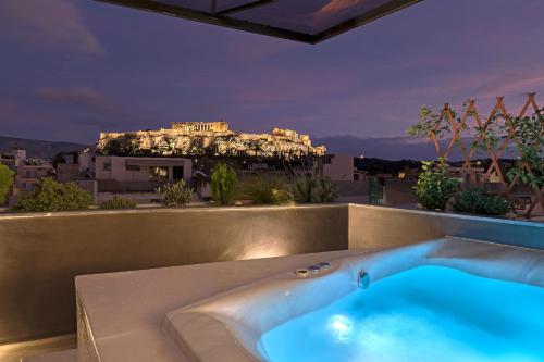 a bath tub with a view of the acropolis at Athenian Lofts in Athens