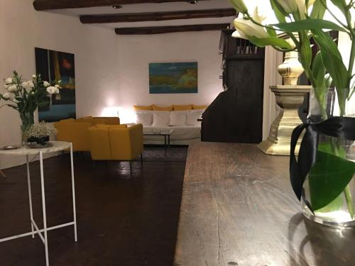 a living room with yellow chairs and a couch at El Molino Estepona in Estepona