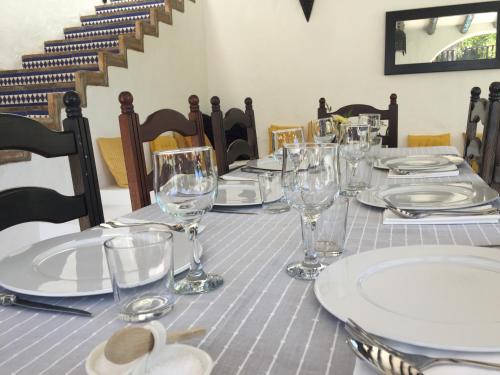 a table with white plates and glasses on it at El Molino Estepona in Estepona