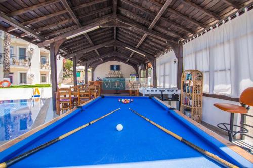a pool table in a room with a swimming pool at Eftelya Apart in Oludeniz