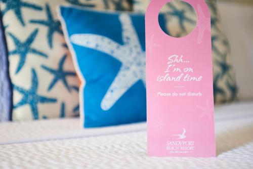 a pink sign sitting on a table with a blue object at Sandyport Beach Resort in Nassau
