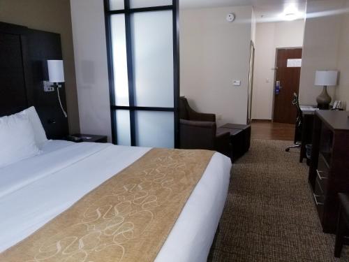 a hotel room with a bed and a desk at Comfort Suites Little Rock West in Little Rock