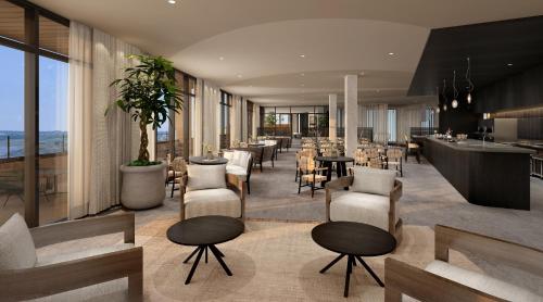 a restaurant with tables and chairs and a bar at Alila Marea Beach Resort Encinitas, a Hyatt Resort in Encinitas