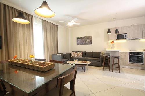 a kitchen and living room with a couch and a table at Skinari Apartments in Monolia