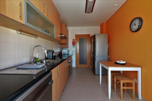 a kitchen with a sink and a refrigerator at Castle in Blue Apartments-Sea View in Sines