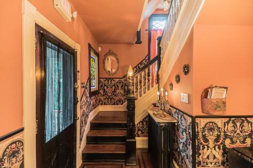 a hallway with a staircase with ornate wallpaper at The Inn on Holly B&B in Pitman