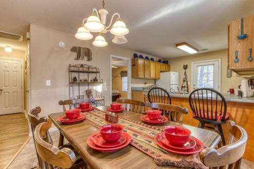 a dining room with a table with red dishes on it at Rock of Ages, Hot Tub, Game Room, WIFI, Free Attraction Tickets, Near Parkway!!! in Pigeon Forge
