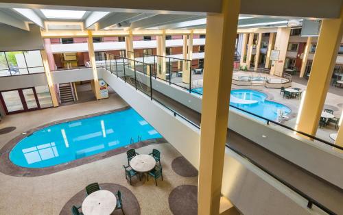 
a hotel lobby with a large swimming pool at Grand Hotel in Minot

