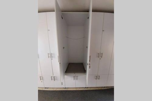 a group of white cabinets in a room at Jahorina apartman 54m2 (za 6 osoba) in Jahorina