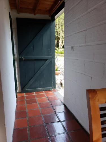 a door in a building with a brick floor at Ensenillo Hotel Boutique in Rionegro