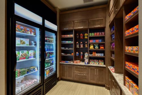 a kitchen with an open refrigerator with food at Staybridge Suites - Waterloo - St. Jacobs Area in Waterloo