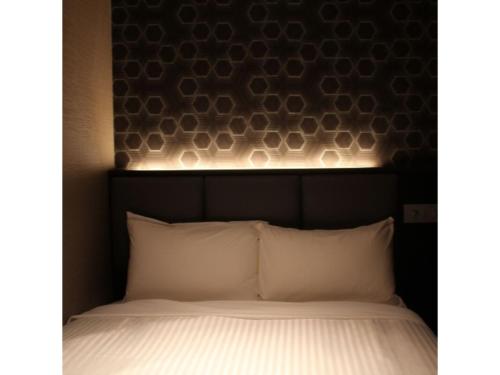 a bed with a headboard with lights above it at Hotel Halrotto Fukuoka Hakata - Vacation STAY 04185v in Fukuoka