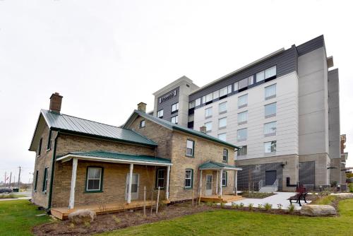 an old brick building next to a large building at Staybridge Suites - Waterloo - St. Jacobs Area in Waterloo