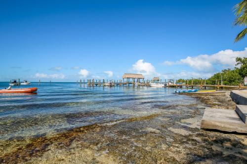 a beach with a pier and boats in the water at Executive Bay Club Condo M-1 in Islamorada