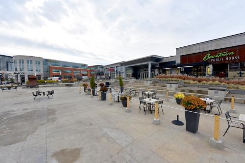 a large parking lot with tables and chairs in front of a building at Staybridge Suites - Waterloo - St. Jacobs Area in Waterloo