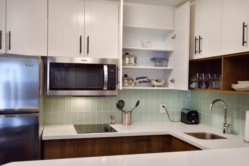 a kitchen with white cabinets and a microwave at Staybridge Suites - Waterloo - St. Jacobs Area in Waterloo