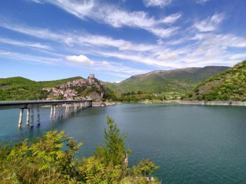 a bridge over a river with mountains in the background at Amazing Lake View in Castel di Tora