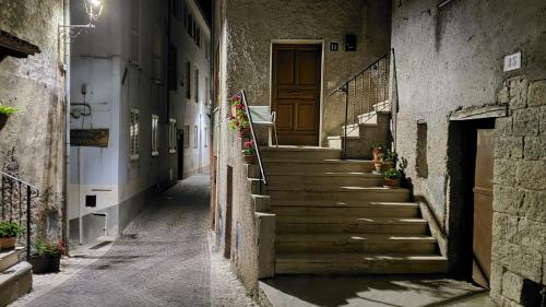 an alley with stairs and a wooden door at Amazing Lake View in Castel di Tora