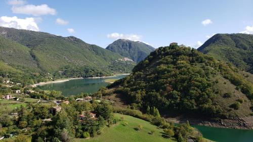 a view of a river between two mountains at Amazing Lake View in Castel di Tora
