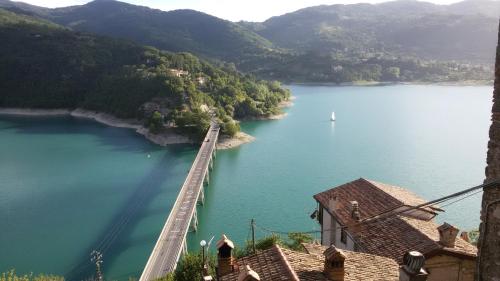 a view of a lake with a bridge over it at Amazing Lake View in Castel di Tora