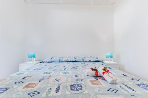 a bed with two stuffed animals sitting on it at Residence Fior di Sulcis in Calasetta