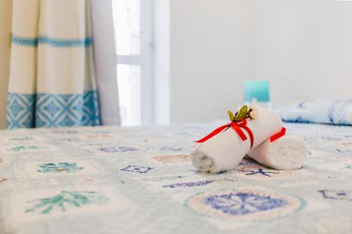 a stuffed animal sitting on top of a bed at Residence Fior di Sulcis in Calasetta